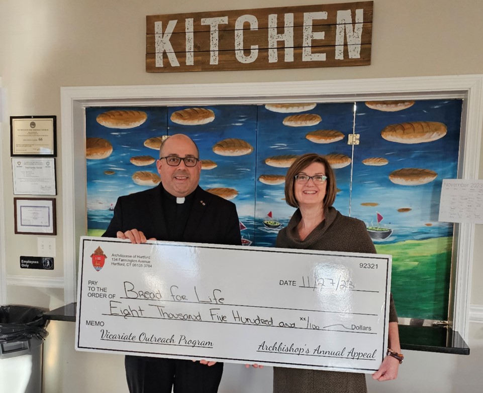 Father Romans delivers a check for $8,500 to Southington Bread for Life. Bread for Life has been a long time recipient of grants from the Archbishop's Annual Appeal's Vicariate Outreach Program which assists local non-profit organizations continue the support that they give to our neighbors in need.